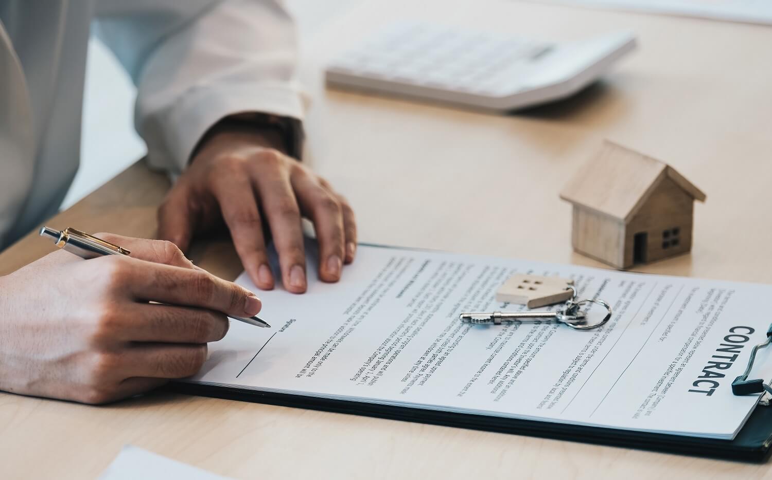 Mężczyzna podpisuje umowe kupując dom
