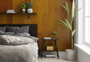 Na tym obrazku możemy zobaczyć urokliwą drewnianą ścianę za łóżkiem w sypialni. Drewno o ciepłej barwie tworzy przytulną atmosferę i dodaje naturalnego charakteru pomieszczeniu. Koncepcja umieszczenia ściany za łóżkiem stanowi interesujący element aranżacji, który przyciąga wzrok i nadaje wnętrzu unikalnego wyrazu. Drewniane deski doskonale kontrastują z innymi elementami wystroju, tworząc harmonijną kompozycję i tworząc wspaniałe tło dla miejsca wypoczynku. Ta ściana stanowi wyrazisty akcent i doskonałe uzupełnienie stylowej sypialni.