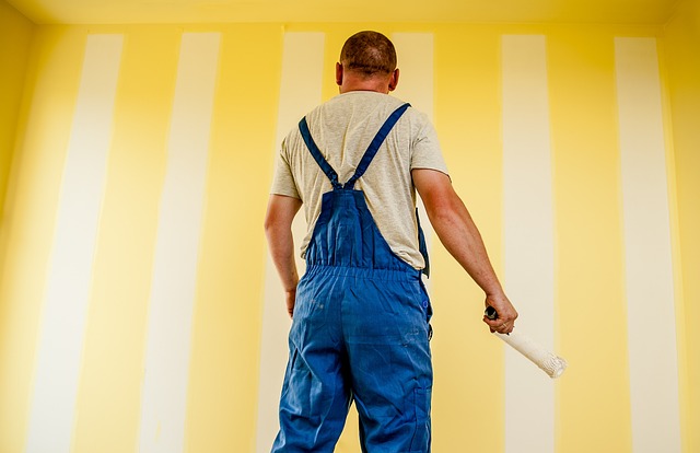 Mężczyzna maluje ściany w domu